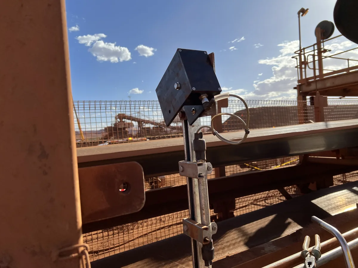 Sensor and bracket clamped to the conveyor structure