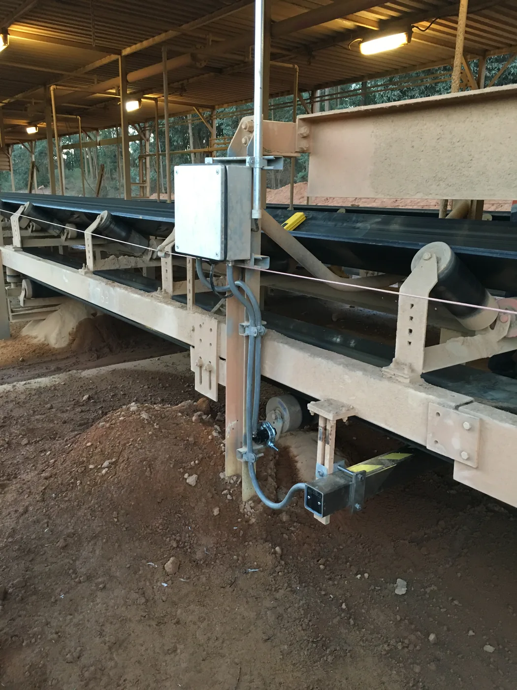 Field electrical enclosure mounted on a conveyor stringer with conduit running down to the scanner beneath the belt.
